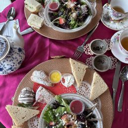 Finger sandwiches, white chocolate covered strawberry, strawberry salad, blueberry and cranberry scones, and tea of the day.