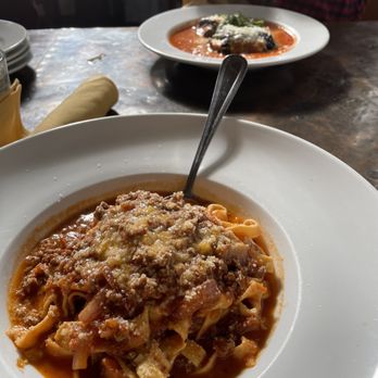 Mizza - Beef Bolognese in the foreground. And the Eggplant Entree in the background. - Italian Near Me - Santa Barbara, California Mizza - Beef Bolognese in the foreground. And the Eggplant Entree in the background. - Italian Near Me - Santa Barbara, California