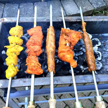 Apna Bazaar - several skewers of food being cooked on a grill - Indian Near Me - Columbus, Ohio Apna Bazaar - several skewers of food being cooked on a grill - Indian Near Me - Columbus, Ohio