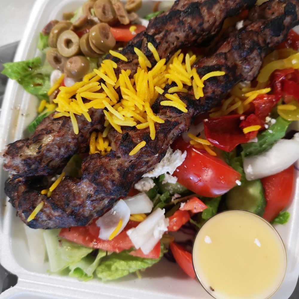 Koobideh kebab with a side of salad Koobideh kebab with a side of salad
