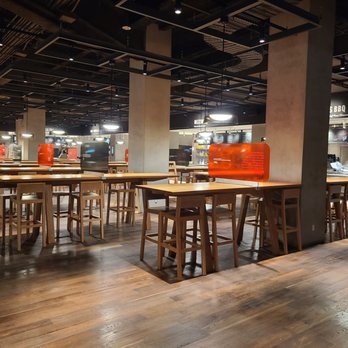Time Out Market - tables and stools in a restaurant - French Near Me - Montreal, Quebec Time Out Market - tables and stools in a restaurant - French Near Me - Montreal, Quebec