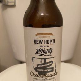 a bottle of beer on a toilet