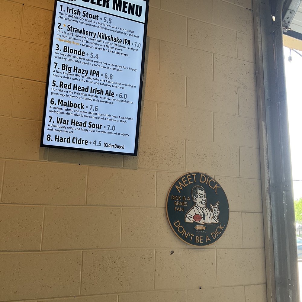 Beer menu and sign inside taproom.