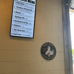 Beer menu and sign inside taproom.
