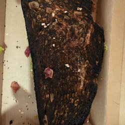 Dunkin' - Burnt to hell avocado toast. Takes balls to serve this. Clearly working the toaster is too big a challenge.