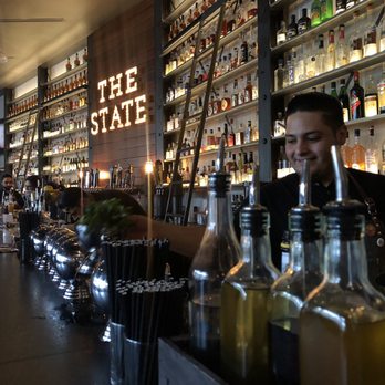 The State - One of the best bartenders with full bar in background - Whiskey Bars Near Me - Rancho Cucamonga, California The State - One of the best bartenders with full bar in background - Whiskey Bars Near Me - Rancho Cucamonga, California