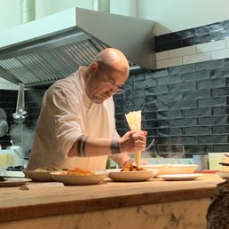The restaurant's owner decorating some delicious Italian plate The restaurant's owner decorating some delicious Italian plate