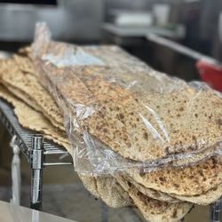 International Market Grill - Persian Style Sangak Bread: Whole wheat flatbread with sesame seeds.
