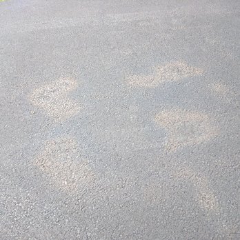 Academy Sealers - Horrible splotches where they applied too much sealant and it never dried properly after 5 (!!) days. Does this driveway look black to you? - Gutter Services Near Me - Sterling, Virginia