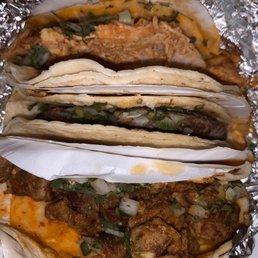 Spicy Chicken, Al Pastor, and Goat Tacos (Top to Bottom)