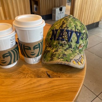 Starbucks - two cups of coffee and a hat on a table - Coffee & Tea Near Me - Lincoln Park, Michigan Starbucks - two cups of coffee and a hat on a table - Coffee & Tea Near Me - Lincoln Park, Michigan