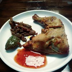Ali's Bistro - Chicken quarter, green mango and pickled carrots.