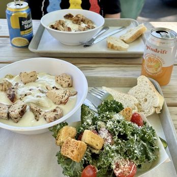 Pasta & Provisions - Two Fettuccine Pastas with Alfredo sauce and chicken. One as a combo with a side kale Caesar salad. - Delis Near Me - Charlotte, North Carolina Pasta & Provisions - Two Fettuccine Pastas with Alfredo sauce and chicken. One as a combo with a side kale Caesar salad. - Delis Near Me - Charlotte, North Carolina