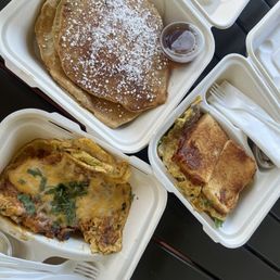 Pancakes, breakfast veggie omelette sandwich with salsa verde on the right, Juan with garlic aioli on the left. Pancakes, breakfast veggie omelette sandwich with salsa verde on the right, Juan with garlic aioli on the left.