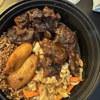 Tony's Jamaican Food - Combo plate: oxtails, jerk chicken, and bread on the side - Caribbean Near Me - Austin, Texas