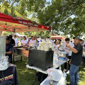 Toby's Tacos - a group of people standing under a tent - Tacos Near Me Toby's Tacos - a group of people standing under a tent - Tacos Near Me