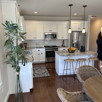 VSGencontractor - a woman standing in a kitchen - General Contractors Near Me - Waltham, Massachusetts