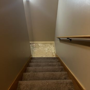 Hardwood Plus - Before pic of stairway and base floor that needed to be replaced. - Flooring Near Me Hardwood Plus - Before pic of stairway and base floor that needed to be replaced. - Flooring Near Me