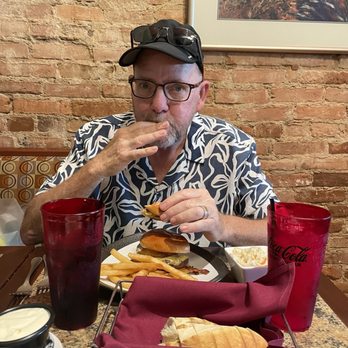 Seasonal Grille - Larry eating his hamburger - Italian Near Me - Hastings, Michigan Seasonal Grille - Larry eating his hamburger - Italian Near Me - Hastings, Michigan