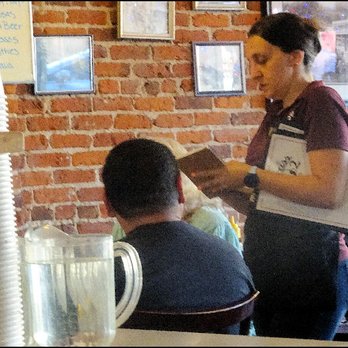 Edelweiss Restaurant 2 - The busy and friendly owner of the restaurant, Jessica, takes breakfast orders from a table of Auburn local diners. - Breakfast & Brunch Near Me - Auburn, California