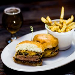 Brasserie Saint James - Brasserie burger with sautéed onions & mushrooms, sharp cheddar, whole grain mustard, tomato jam on a brioche bun.