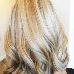 Gray's Hair Studio - Soft blonde balayage with dimensional highlights, loose curls, and a smooth layered finish for a bright, modern look.