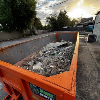 Dumpster Strong - Roll-off dumpster filled with construction debris for a renovation project in Florida. - Dumpster Rental Near Me - Orlando, Florida Dumpster Strong - Roll-off dumpster filled with construction debris for a renovation project in Florida. - Dumpster Rental Near Me - Orlando, Florida