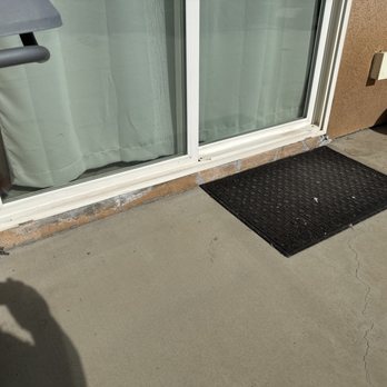 Painting Enterprise - Cracks and liquid cement holding together the bottom of the sliding glass door - Painters Near Me Painting Enterprise - Cracks and liquid cement holding together the bottom of the sliding glass door - Painters Near Me