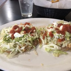 Maria's Mexican Restaurant - Chicken Tostada layered with refried beans, shredded cheese, shredded chicken, shredded lettuce, guacamole, sour cream, and hot hot sauce.