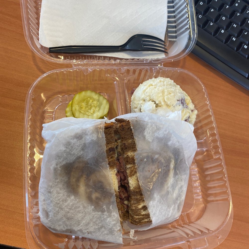 Pastrami on marble rye with potato salad and pickles