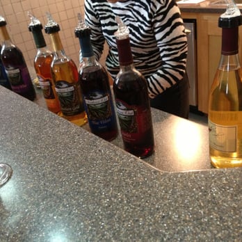White Oak Vineyards - a woman behind a counter with bottles of wine - Wineries Near Me - Anniston, Alabama White Oak Vineyards - a woman behind a counter with bottles of wine - Wineries Near Me - Anniston, Alabama