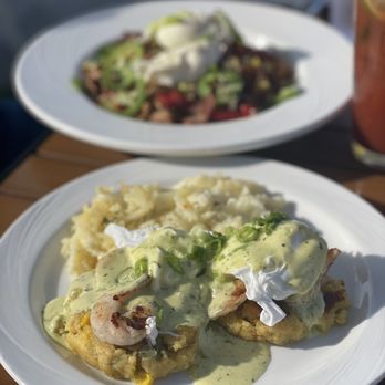 Duke's on 7 - SHRIMP & SALSA VERDE BENNY Grilled shrimp, poached egg, salsa verde hollandaise and served on a tamale cake. Served with creamy hash - Cocktail Bars Near Me - Minnetonka, Minnesota Duke's on 7 - SHRIMP & SALSA VERDE BENNY Grilled shrimp, poached egg, salsa verde hollandaise and served on a tamale cake. Served with creamy hash - Cocktail Bars Near Me - Minnetonka, Minnesota