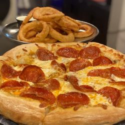 Hideout Saloon - Order up!! Pizza for one and beer battered onion rings for another. Enjoy!
