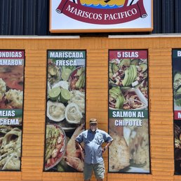 Standing outside near the entrance of the restaurant. Standing outside near the entrance of the restaurant.