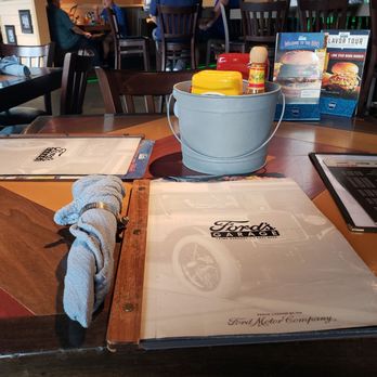 Ford's Garage Florence - Menu, grease rags w/ hose clamps, condiments in a bucket - Burgers Near Me - Florence, Kentucky Ford's Garage Florence - Menu, grease rags w/ hose clamps, condiments in a bucket - Burgers Near Me - Florence, Kentucky