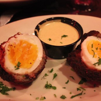 Redcoat Tavern - Scotch Egg appetizer. It's a boiled egg encased in sausage with a mustard sauce for dipping. - Bars Near Me - Royal Oak, Michigan Redcoat Tavern - Scotch Egg appetizer. It's a boiled egg encased in sausage with a mustard sauce for dipping. - Bars Near Me - Royal Oak, Michigan