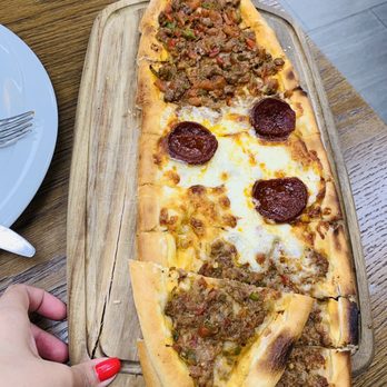 Turkish Shashlik Kebab - a person cutting a pizza - Desserts Near Me - Mississauga, Ontario
