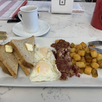 Ce La Vi - Two eggs over easy, corned beef hash, breakfast potatoes and rye toast. - Desserts Near Me - Red Bank, New Jersey Ce La Vi - Two eggs over easy, corned beef hash, breakfast potatoes and rye toast. - Desserts Near Me - Red Bank, New Jersey