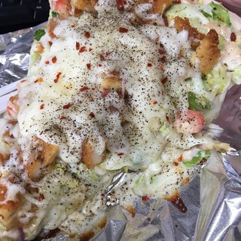 J M Pizza - a hand holding a piece of pizza - Pizza Near Me - Far Rockaway, New York