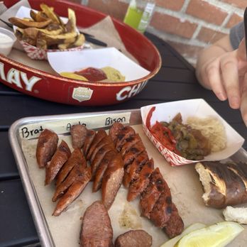 Wursthaus - Platter with Smoked Bratwurst Sausage, Andouille Sausage, Bison Sausage. Plus fries and a drink! - Pubs Near Me - Santa Ana, California Wursthaus - Platter with Smoked Bratwurst Sausage, Andouille Sausage, Bison Sausage. Plus fries and a drink! - Pubs Near Me - Santa Ana, California