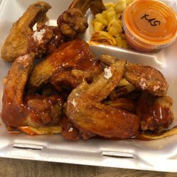 Smoke & Jerk BBQ - Fried chicken wings. There are fries hidden underneath, too!