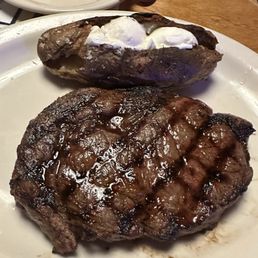 A ribeye and a baked potato A ribeye and a baked potato
