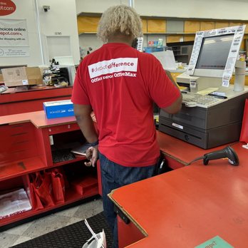Officemax - Inattentive cashier on his phone - Office Equipment Near Me - Birmingham, Alabama