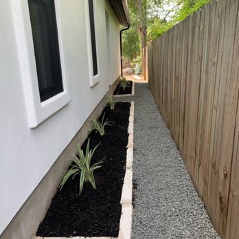 Flores Landscaping - Fence and black start gravel pathway - Landscaping Near Me - Austin, Texas Flores Landscaping - Fence and black start gravel pathway - Landscaping Near Me - Austin, Texas