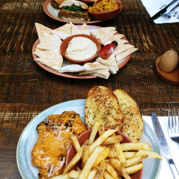 Nando's Peri-Peri - Extra hot chicken breast, hummus with peri peri drizzle served with pita and a veggie burger. - South African Near Me - Towson, Maryland Nando's Peri-Peri - Extra hot chicken breast, hummus with peri peri drizzle served with pita and a veggie burger. - South African Near Me - Towson, Maryland