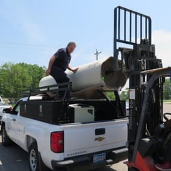Auction Masters - A roll of carpet being loaded at a recent Auction Masters auction.