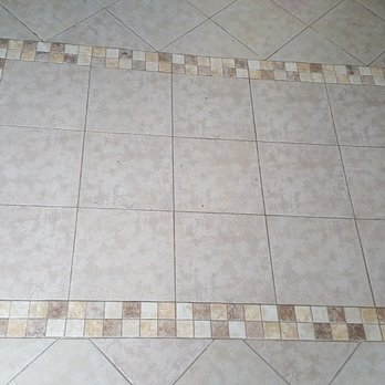 A1 Able Painting & Remodeling - Tile floors laid on the diamond pattern with an inlaid decorative rug. - Painters Near Me