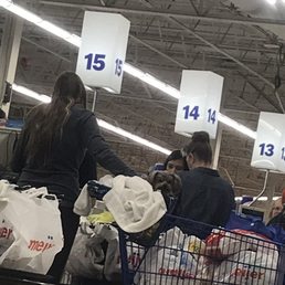 A dog in a shopping cart (which is against health code) trying to jump out of the cart at my dog