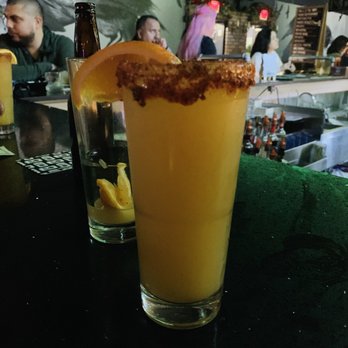 The Hound Bar - Angry orchard with orange juice, orange slice, chamoy and tajin on the rim - Bars Near Me - South Gate, California