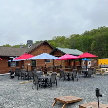 The Outpost - tables and umbrellas outside of a restaurant - Delis Near Me - Pond Eddy, New York The Outpost - tables and umbrellas outside of a restaurant - Delis Near Me - Pond Eddy, New York